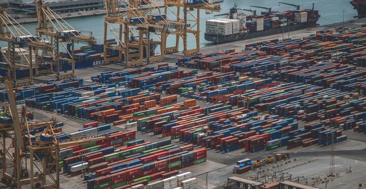 Containers and cargo ports enable global transportation.